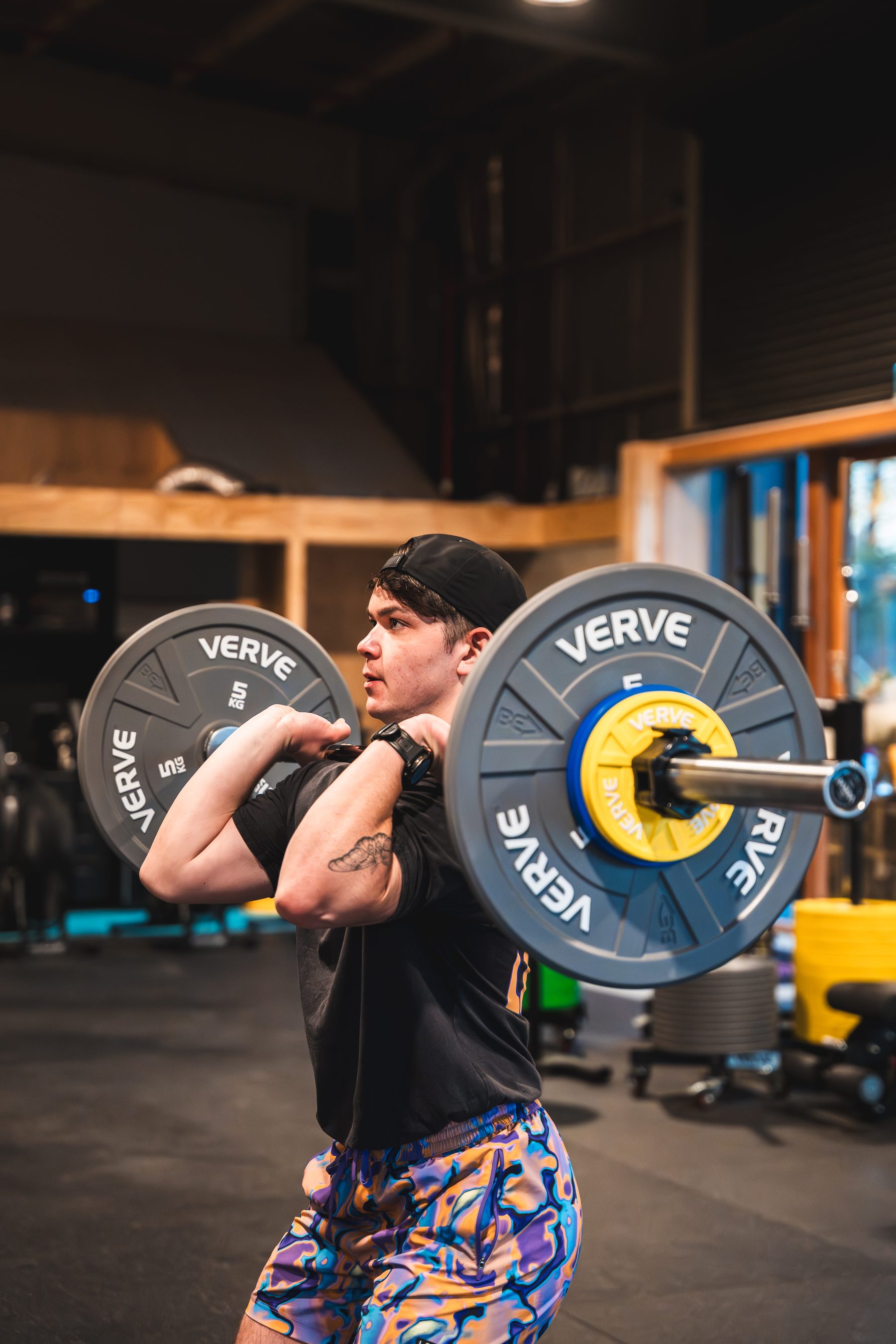 Weight plates and barbells on a commercial gym floor